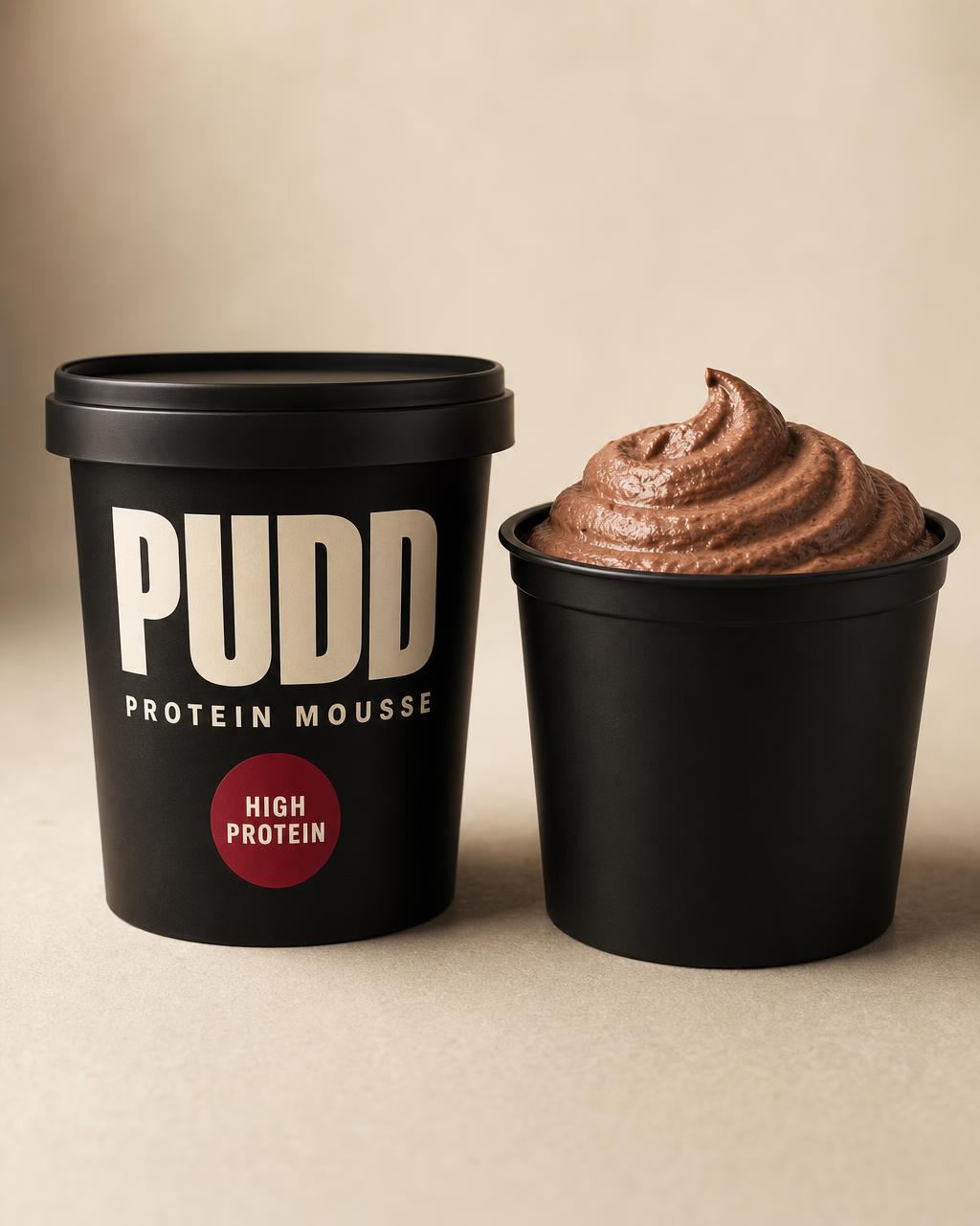 PUDD Protein Mousse concept packaging in matte black with cream PUDD wordmark