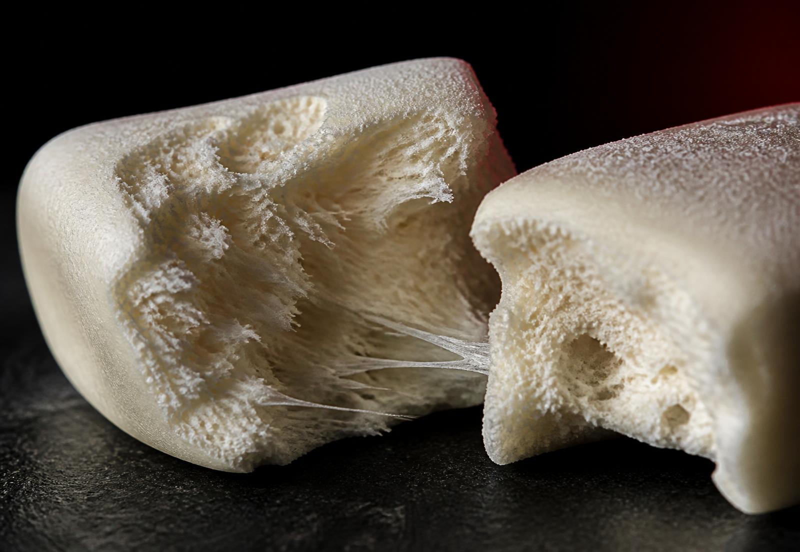 Macro of a PUDD pillow torn open showing its soft, fluffy interior